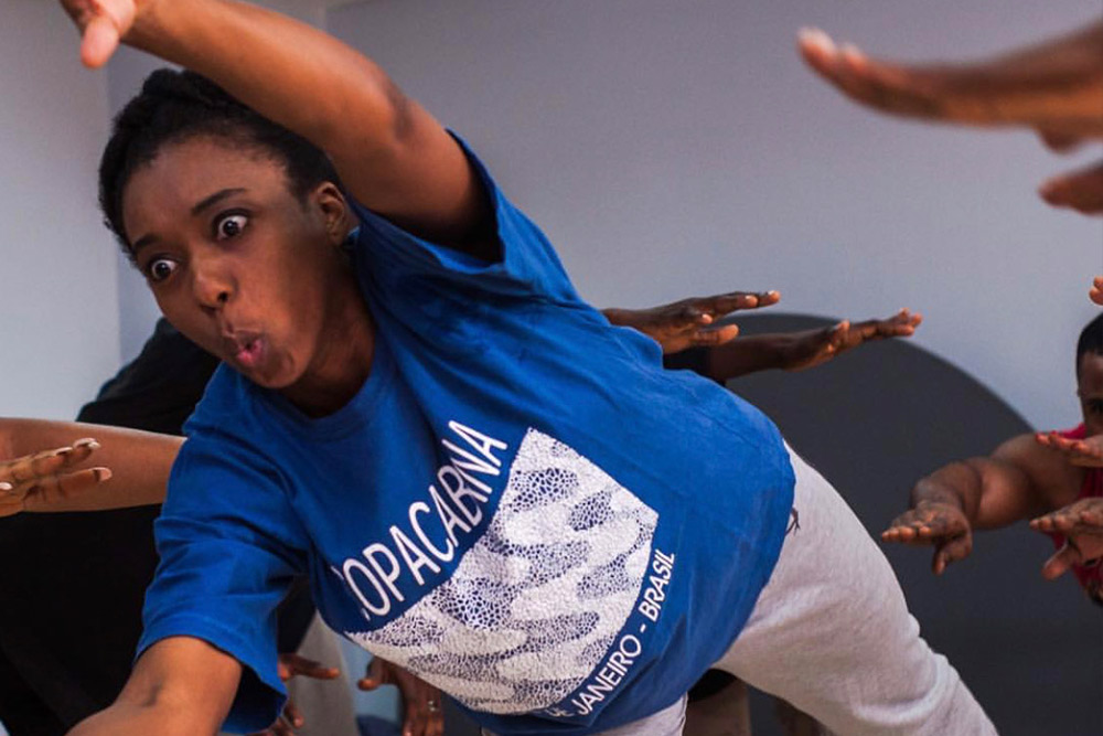 A LAPA student mid-movement in a studio class, arm extended, face fully committed to the exercise.